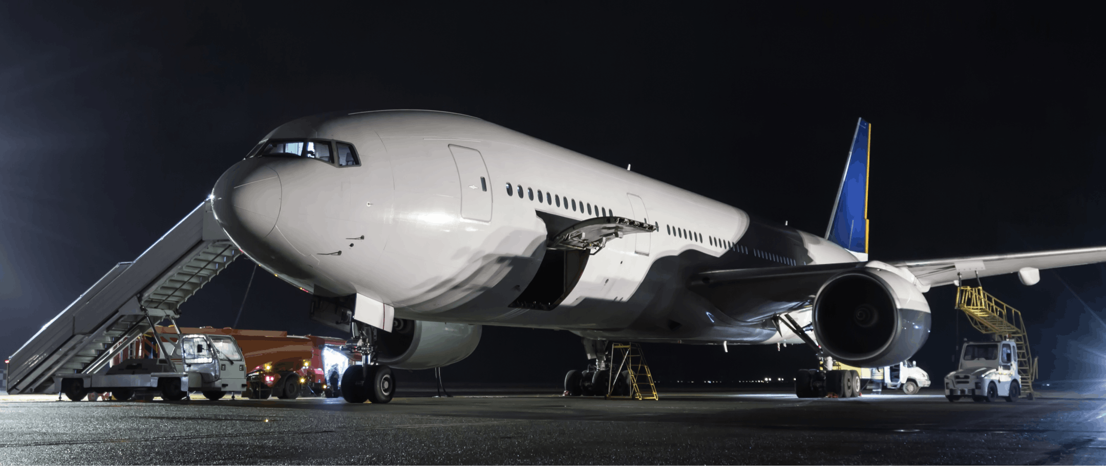 wide-body-passenger-aircraft-with-air-stairs-night-airport-apron-airplane-ground-handling 1 (1)